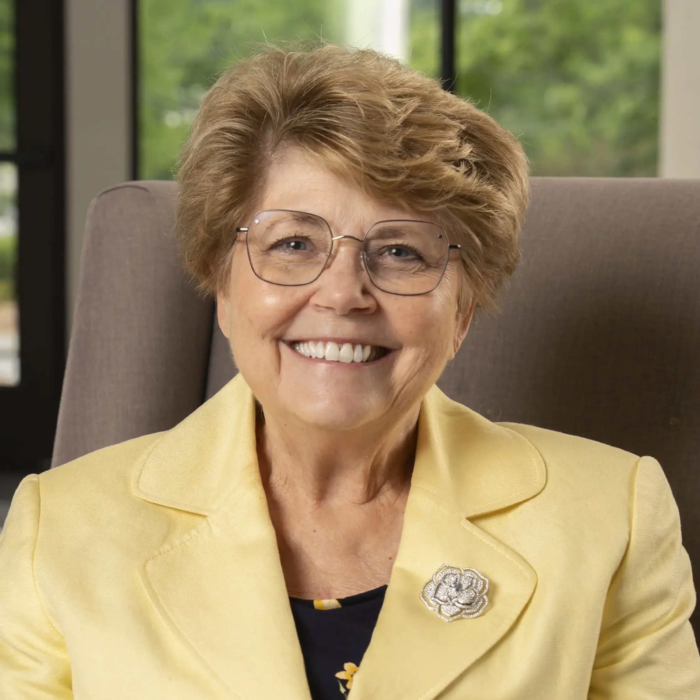 Cheryl smith sitting and smiling at the camera