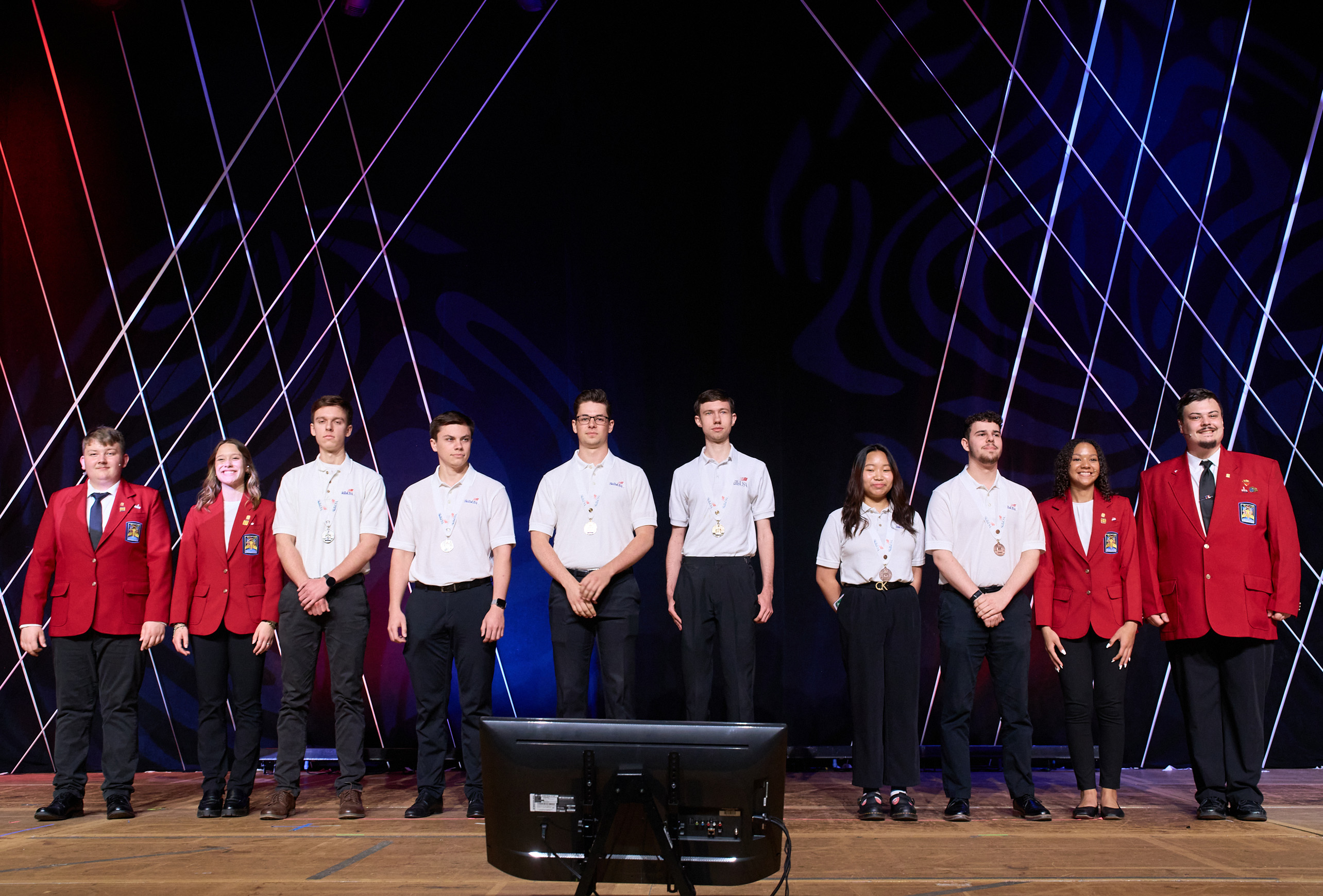 The six students who participated in the SkillsUSA collegiate division state championship stand on stage as they are presented as the winners of this year's Web Design and Development competition.