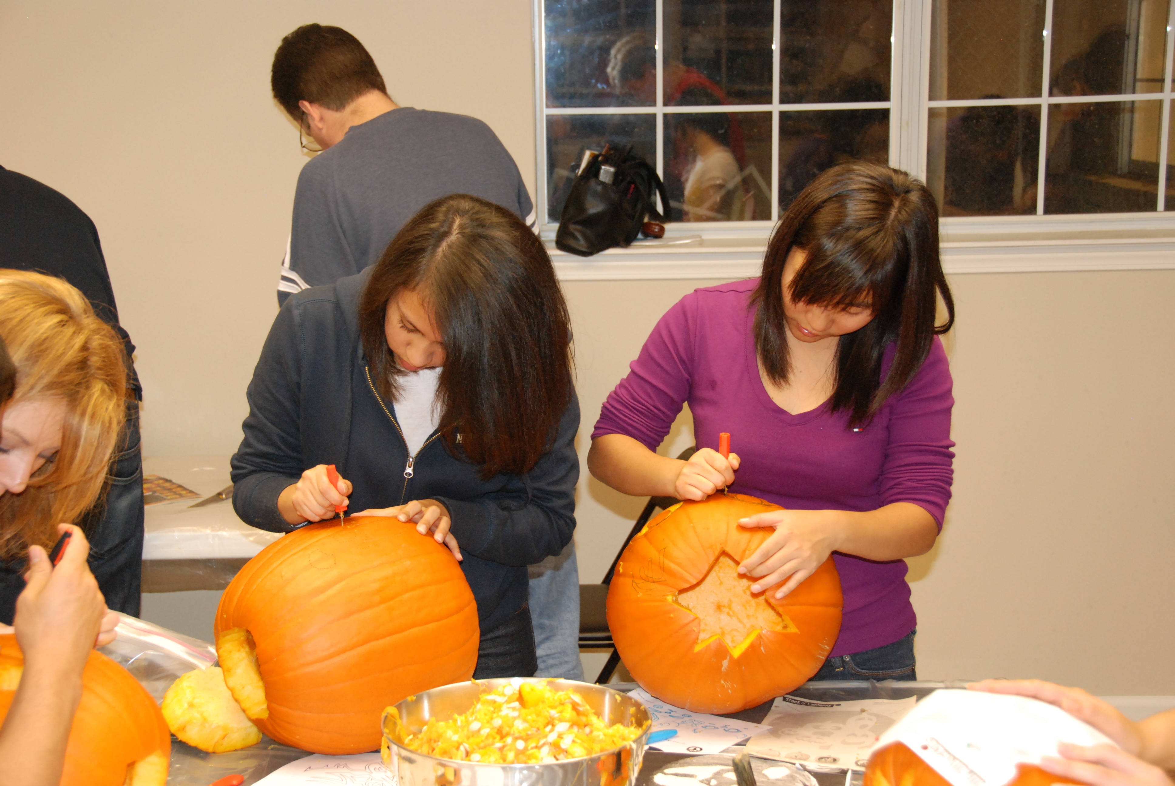 People carving pumpkins