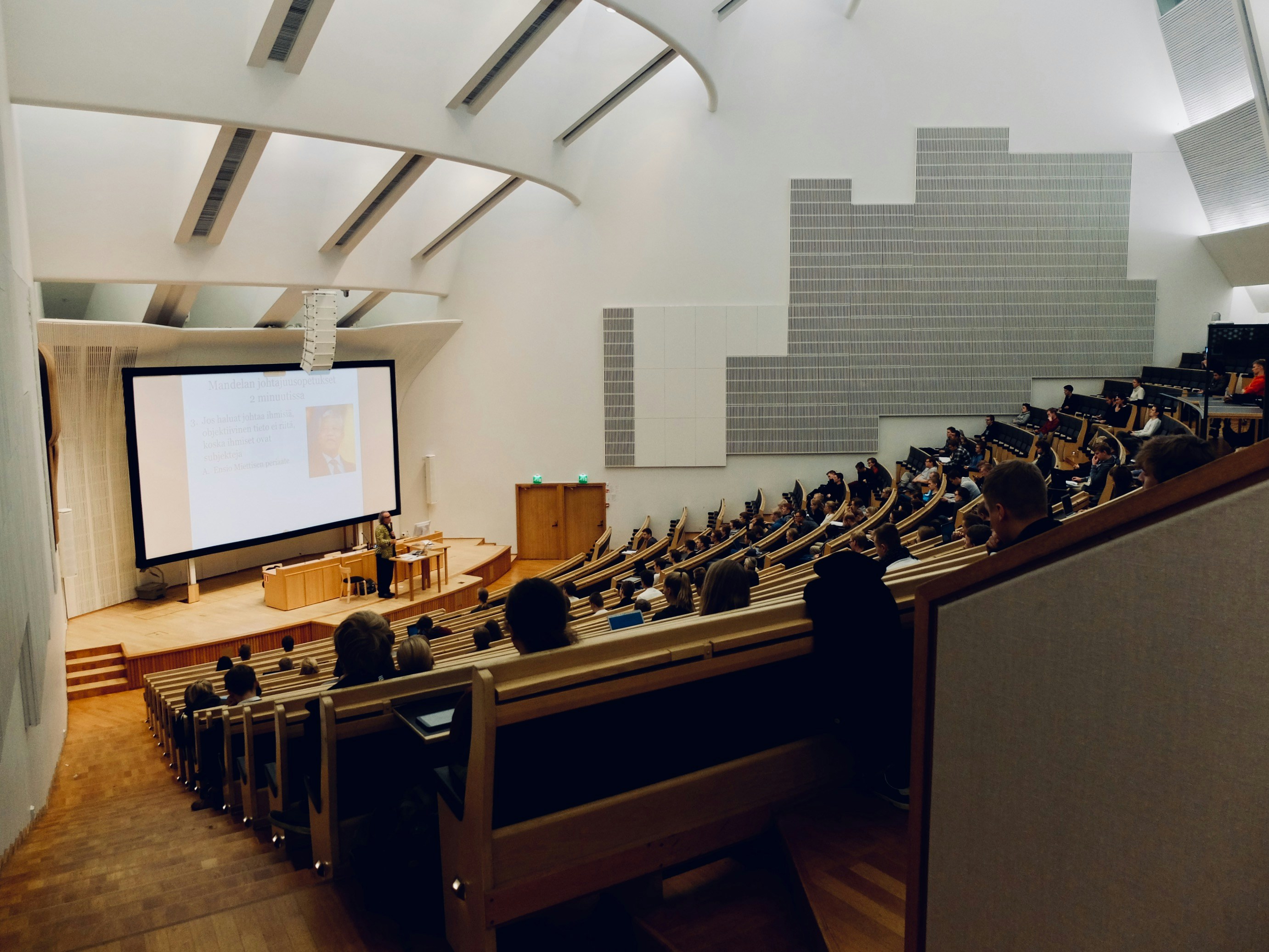 Students in classroom listening to lecture. 