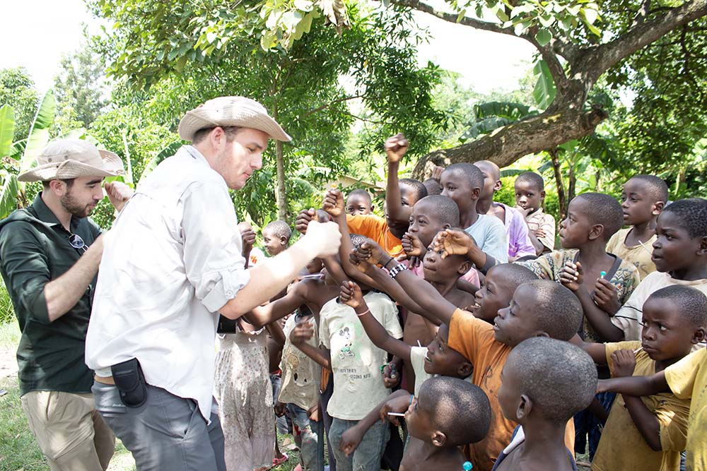 Roman Johnson, '24, and Collin Glenn, senior business administration major, engage with village children.