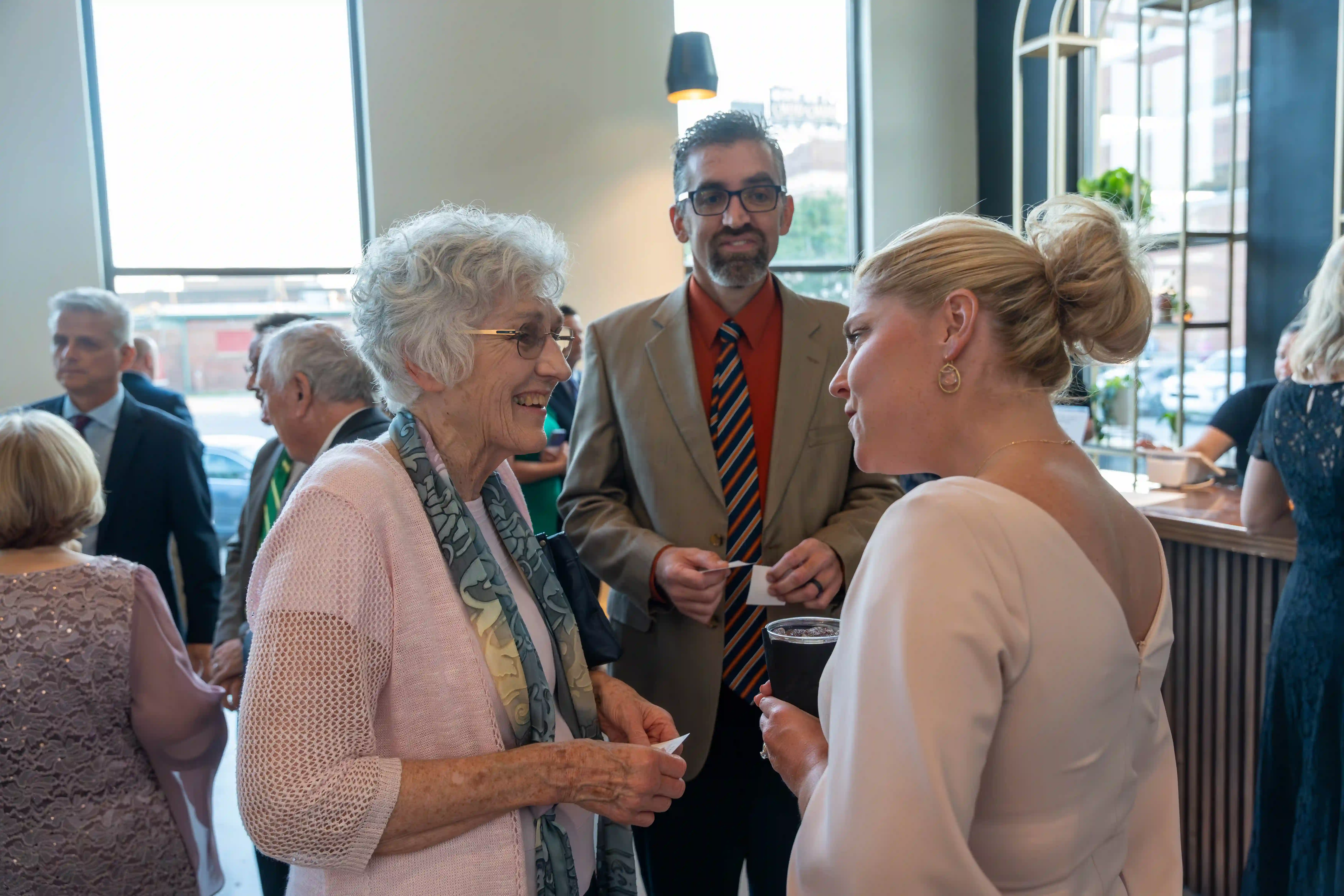 Verlyne and Chad Starr talking with Lynn Brown in the lobby