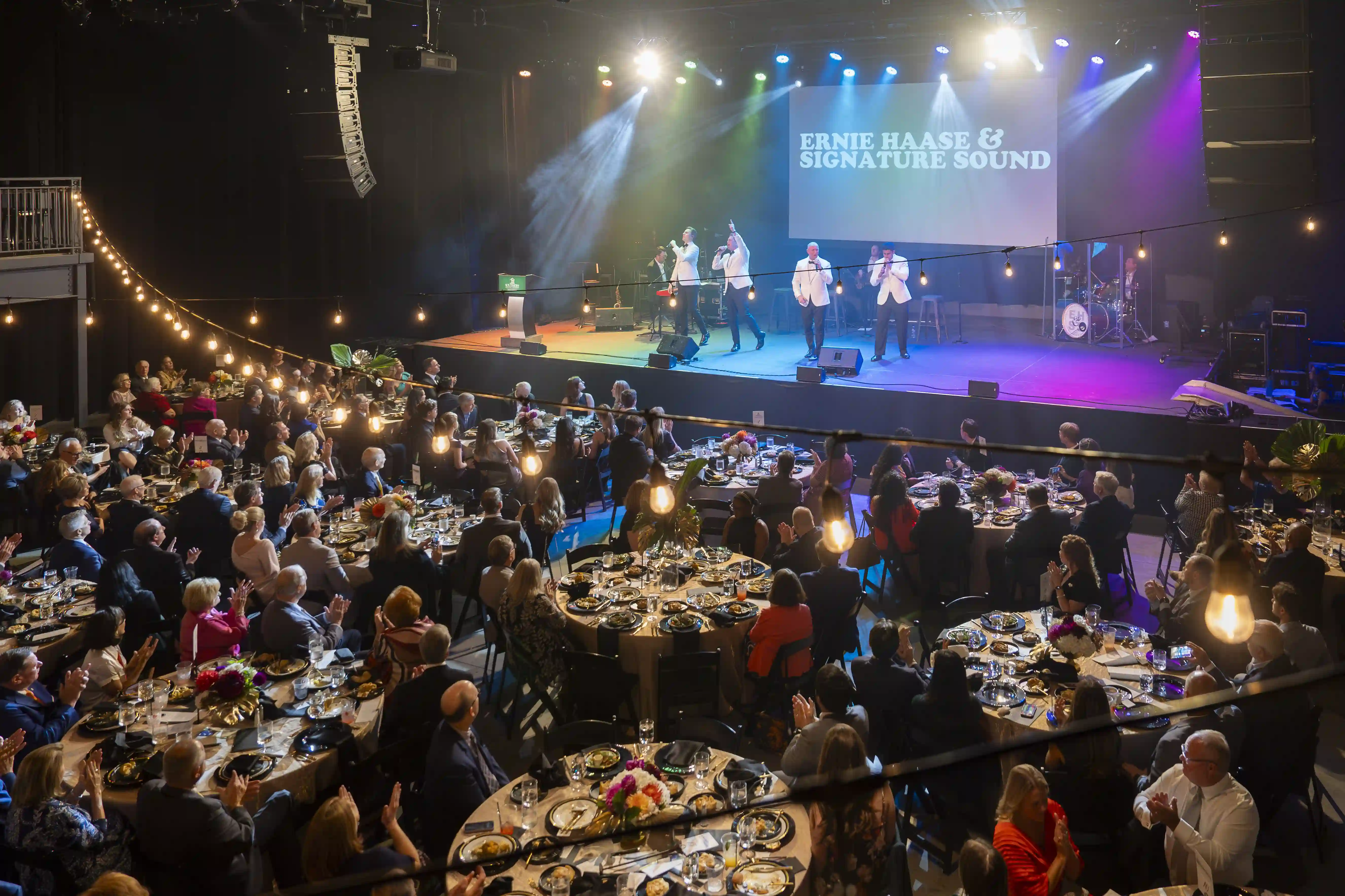 Overhead view of guests seated at tables while Ernie Haase and Signature Sound performs