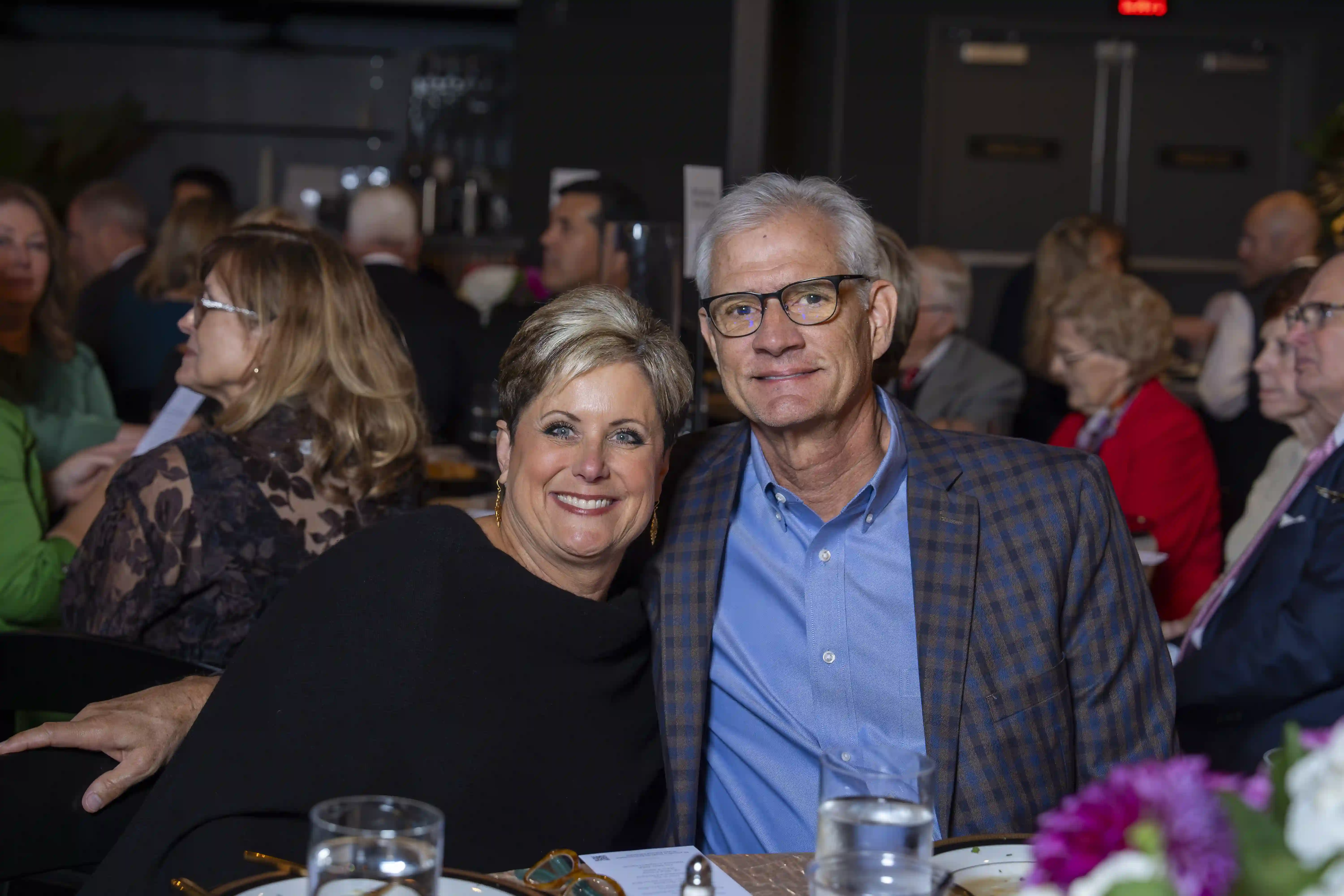 Laurie and Chip Liles seated next to each other, posing for a photo