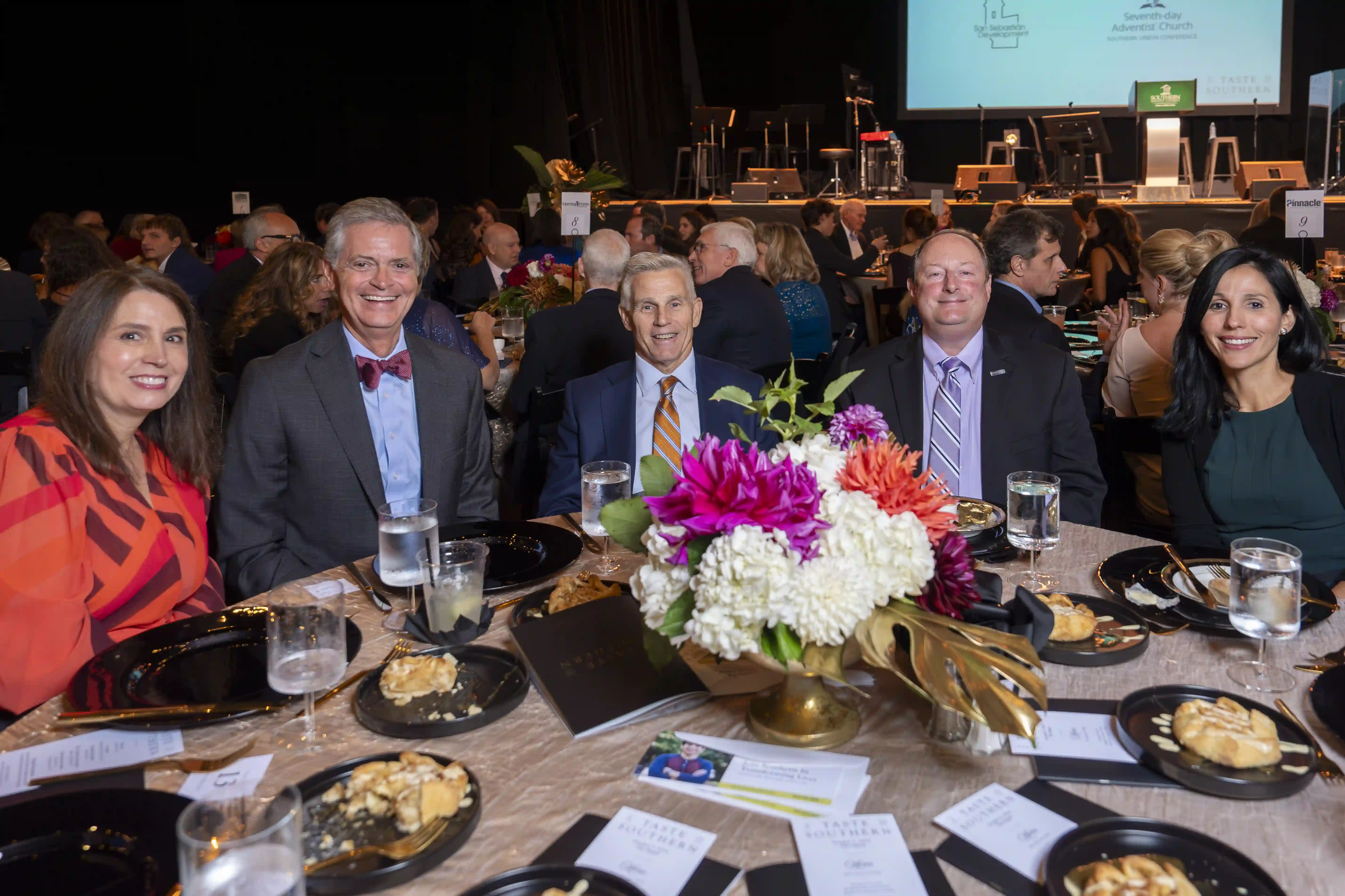 Gloria Stewart, Mark Stewart, Baron Herdelin-Doherty, Harry Gross, Eliza DeLaughter sit at a round table posing for the picture during the dinner portion of the evening. 