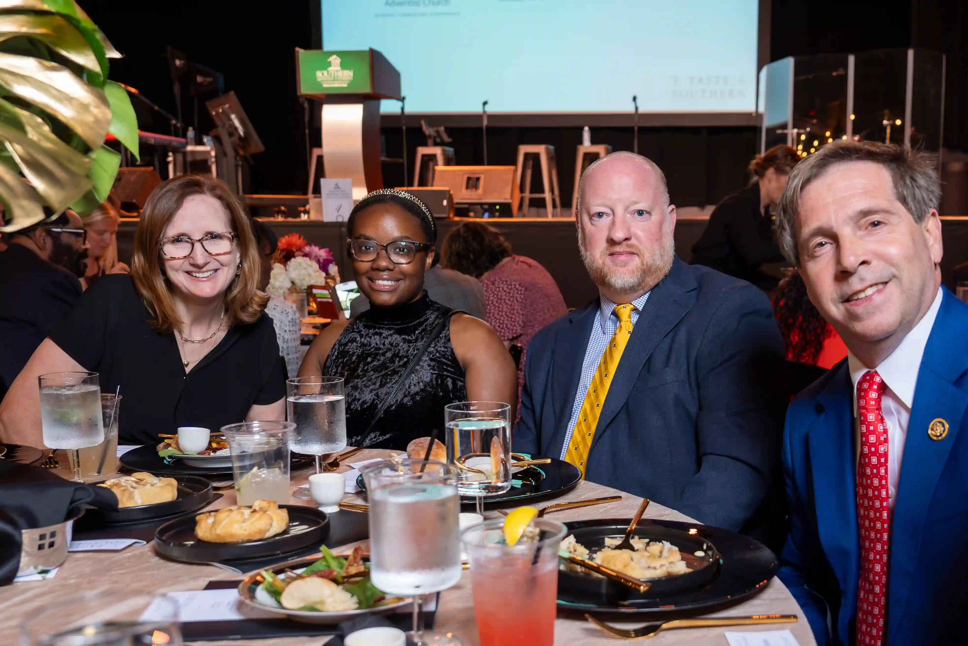 Alison Gerber, Tierra Hayes, Keith Locke, Chuck Fleischmann sit at a round table posing for the picture during the dinner portion of the evening.