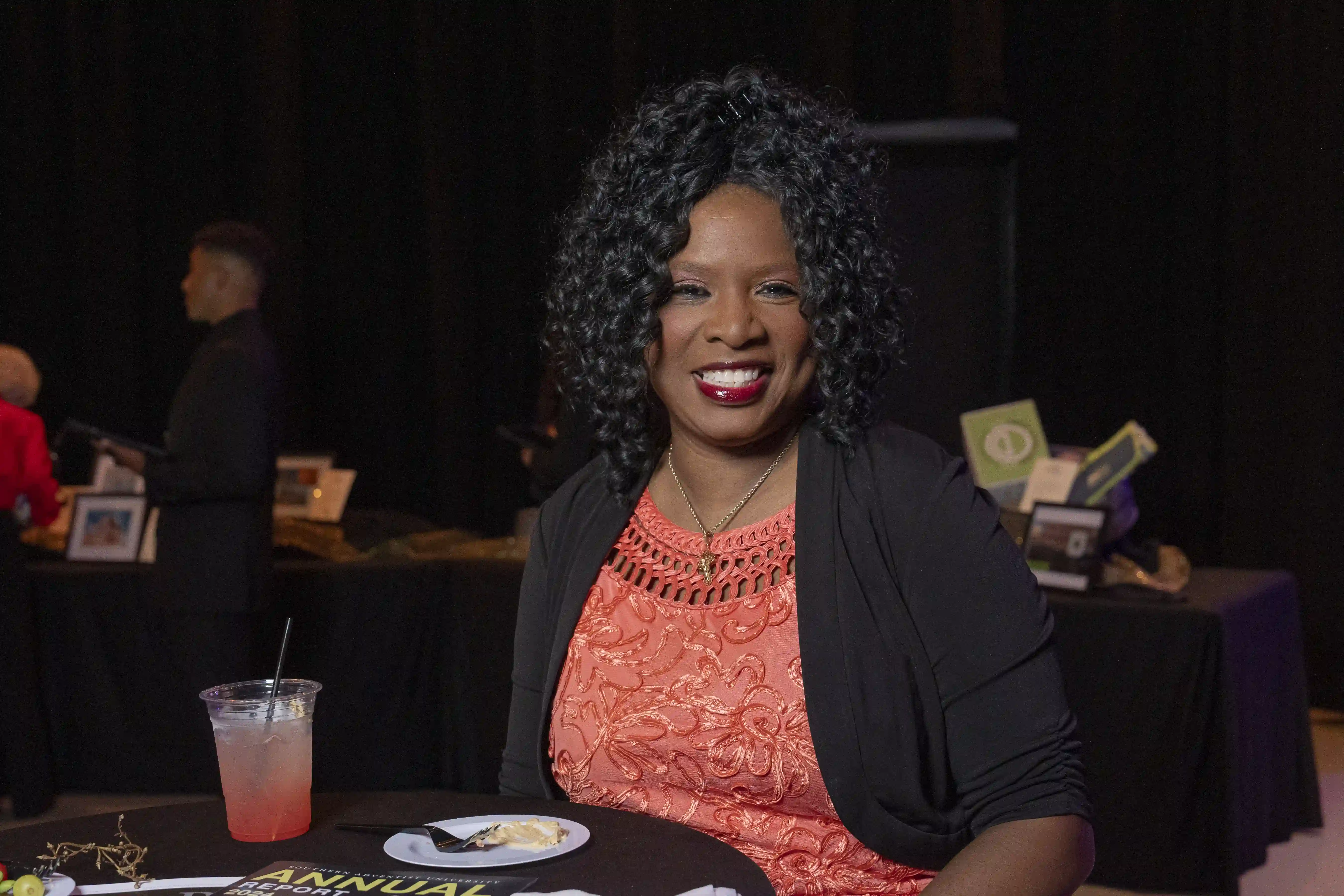 Yolanda Mills seated at a table, smiling for the camera