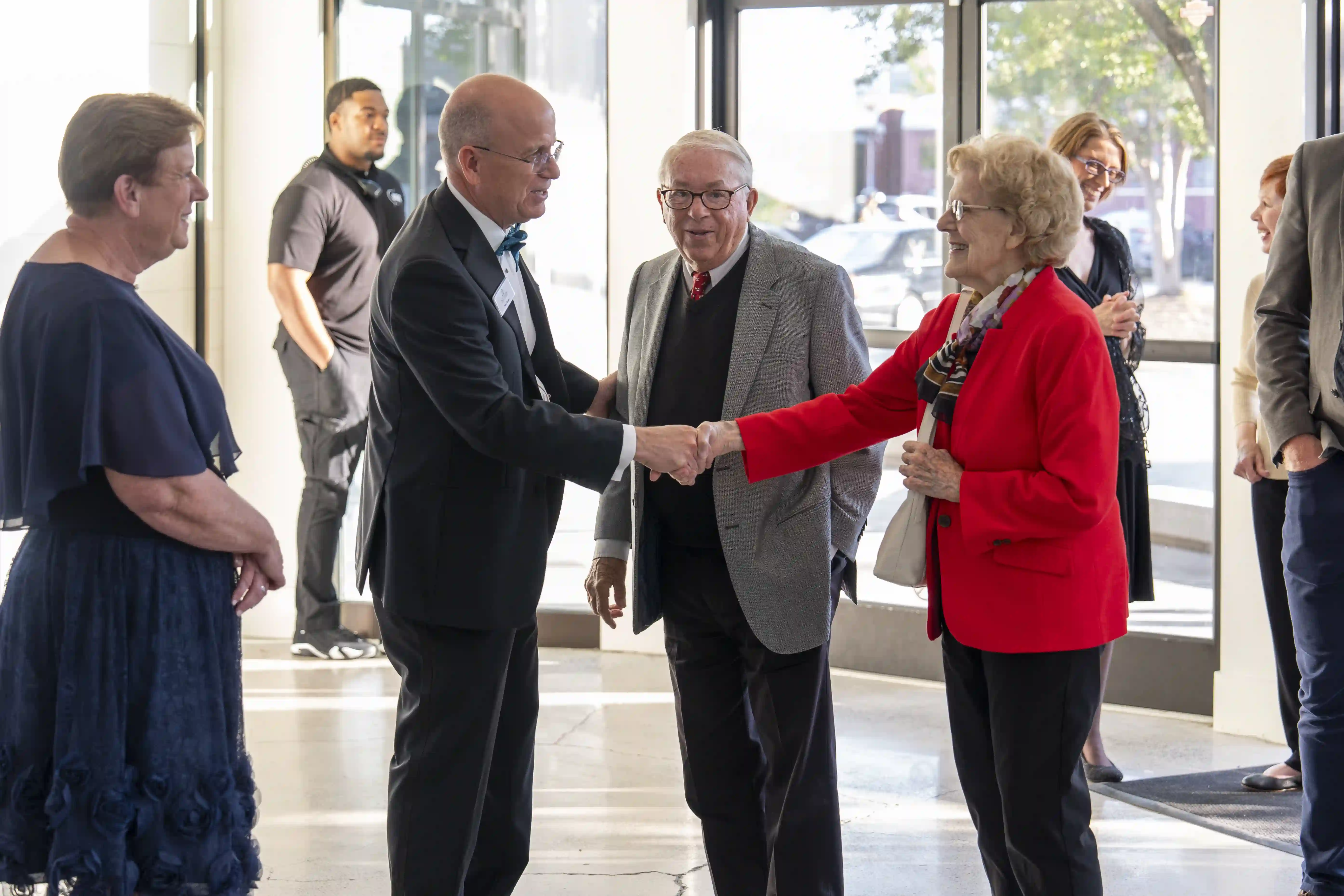 Ken Shaw shaking Norma Bowers' hand as Bob Bowers and Ann Shaw stand near by