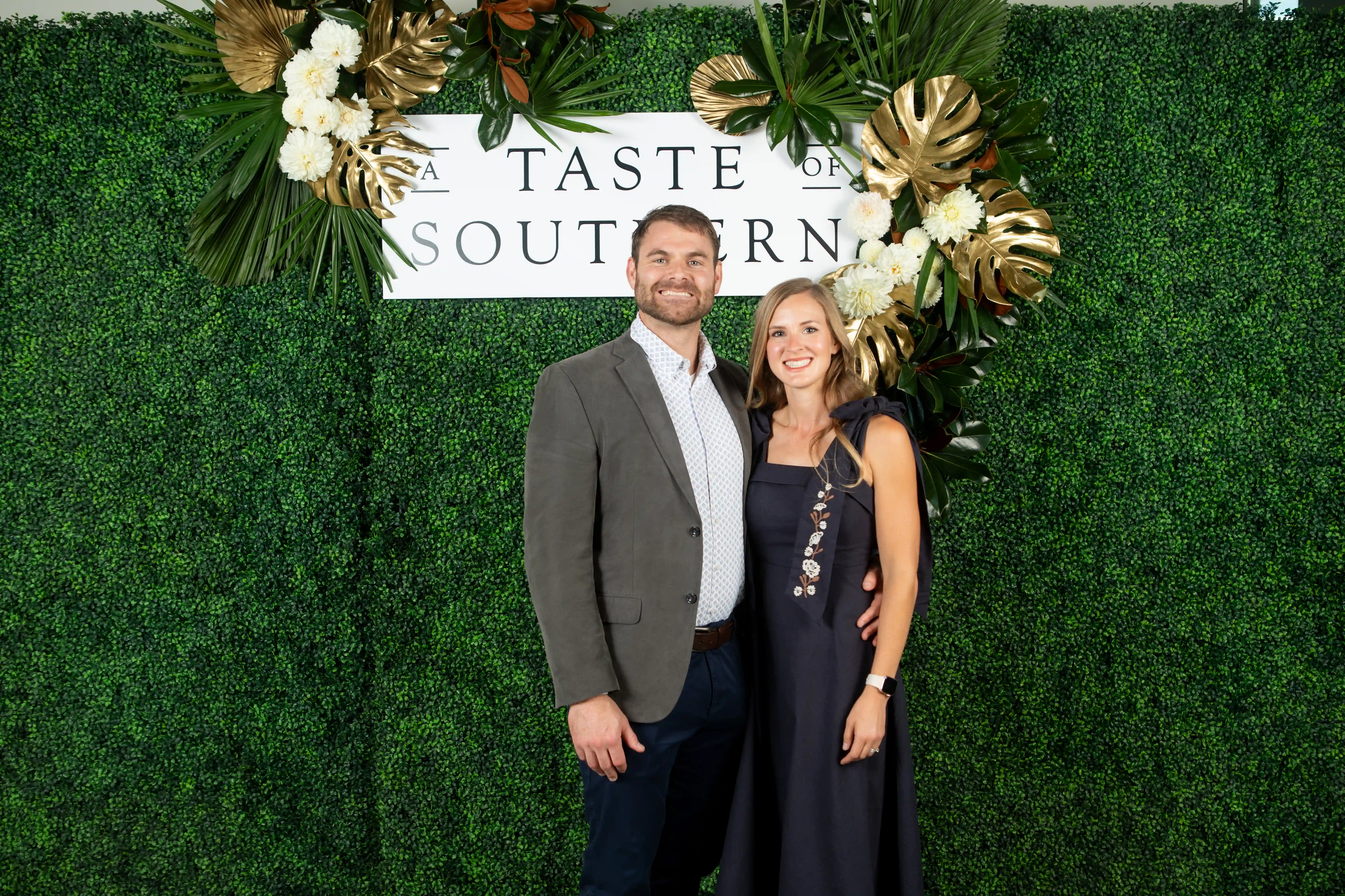 Nathan and Bethany McKee standing side-by-side in front of a green backdrop