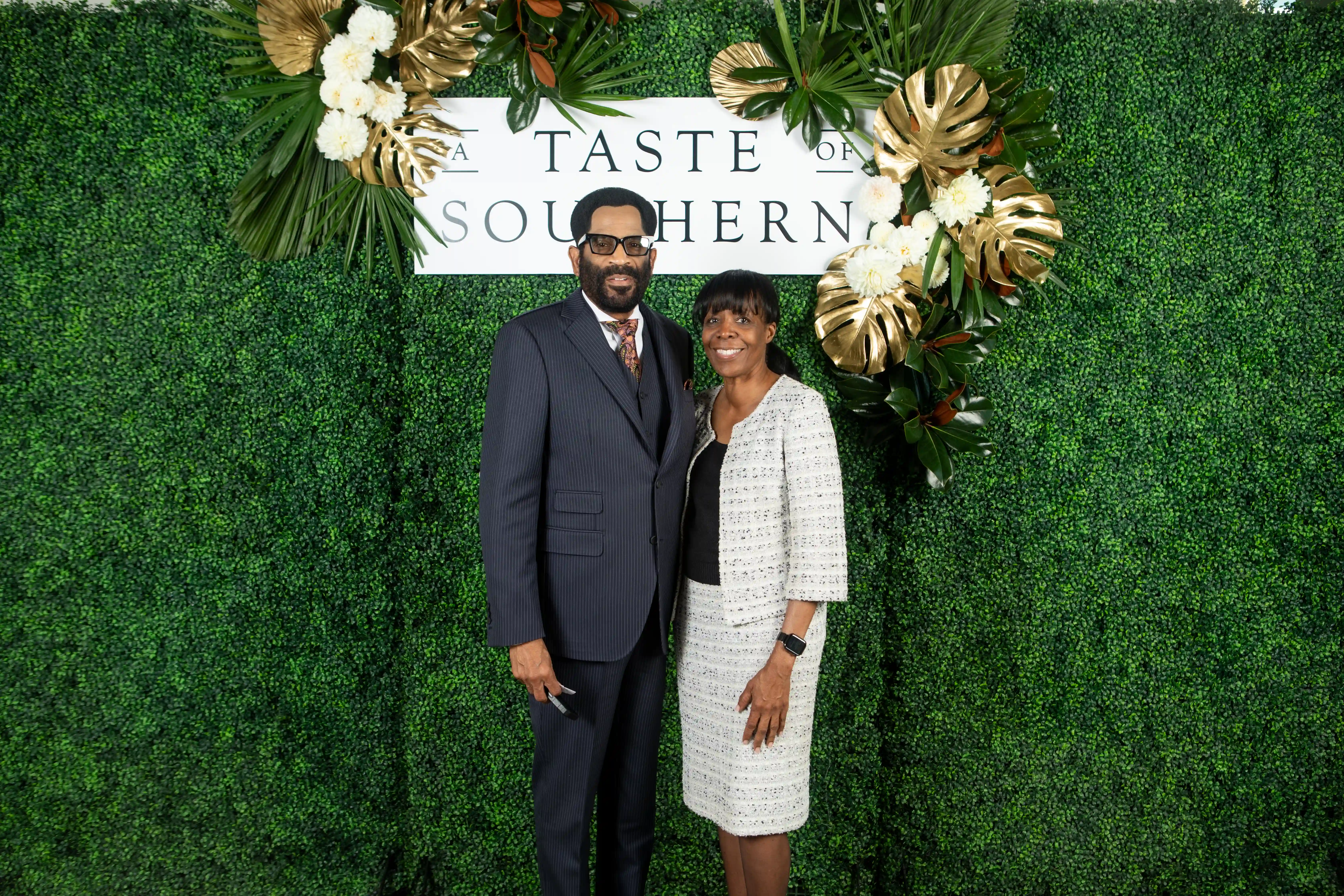 Ron and Yolanda Smith embracing side-by-side in front of a green backdrop