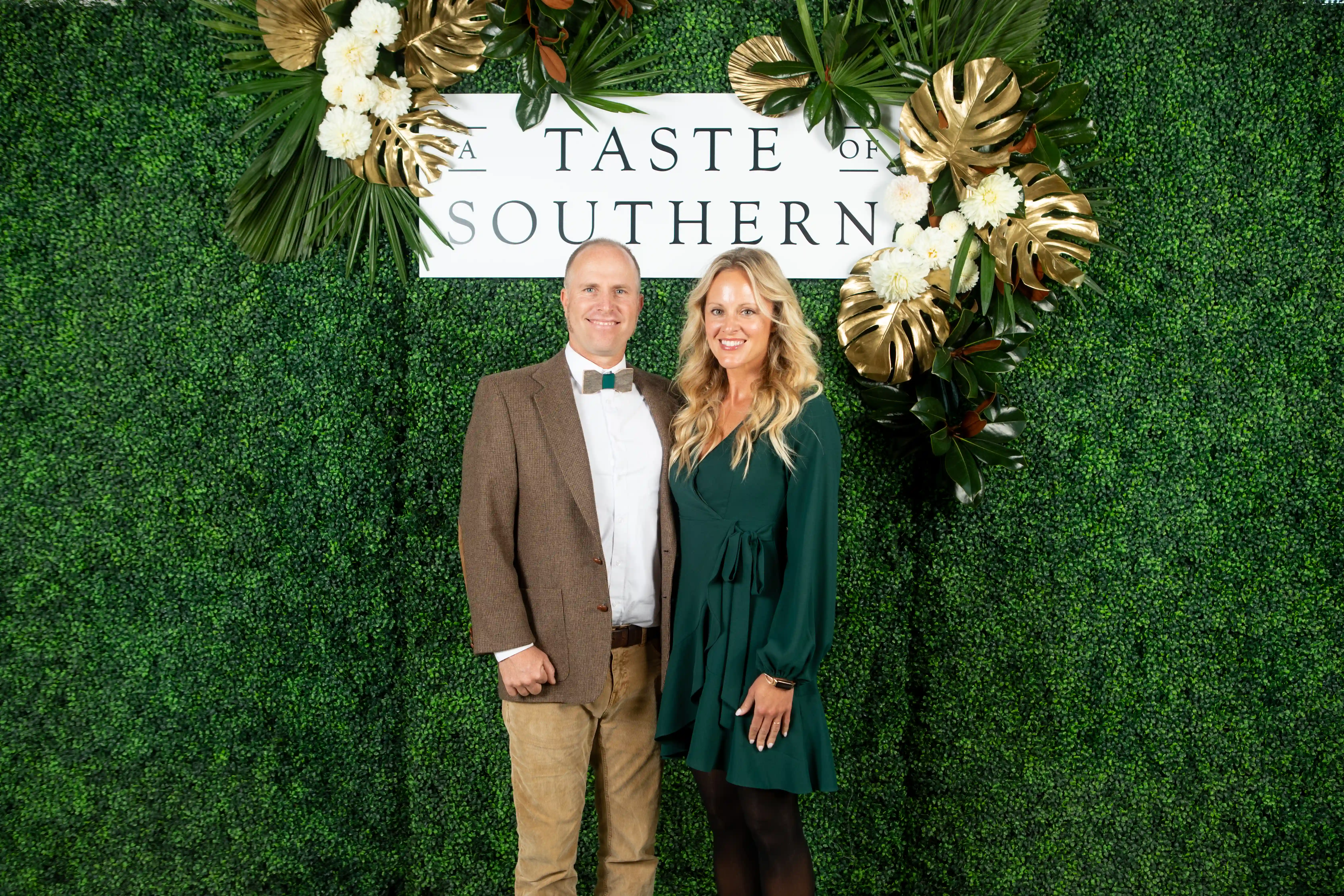 Caleb and Kelly Knowles embracing side-by-side in front of a green backdrop